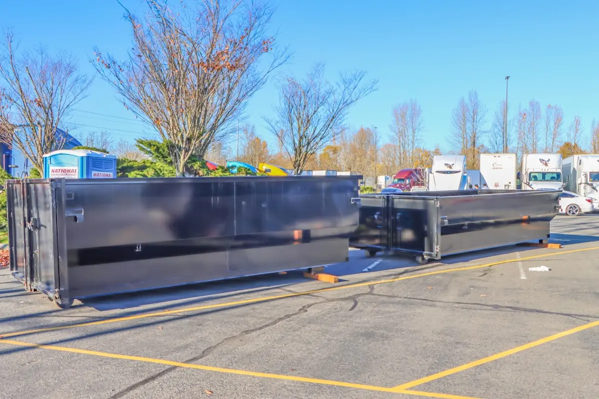 Professional dumpster rental service with roll-off container on residential driveway in Atlantic